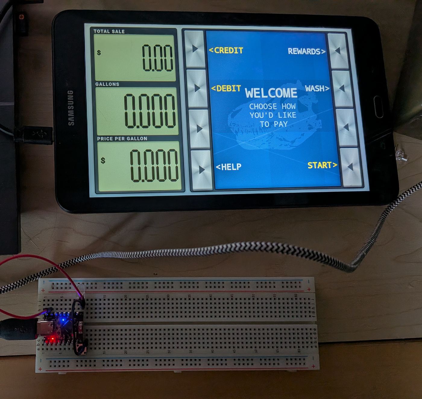 The gas pump screen and an ESP32 on a breadboard, during testing